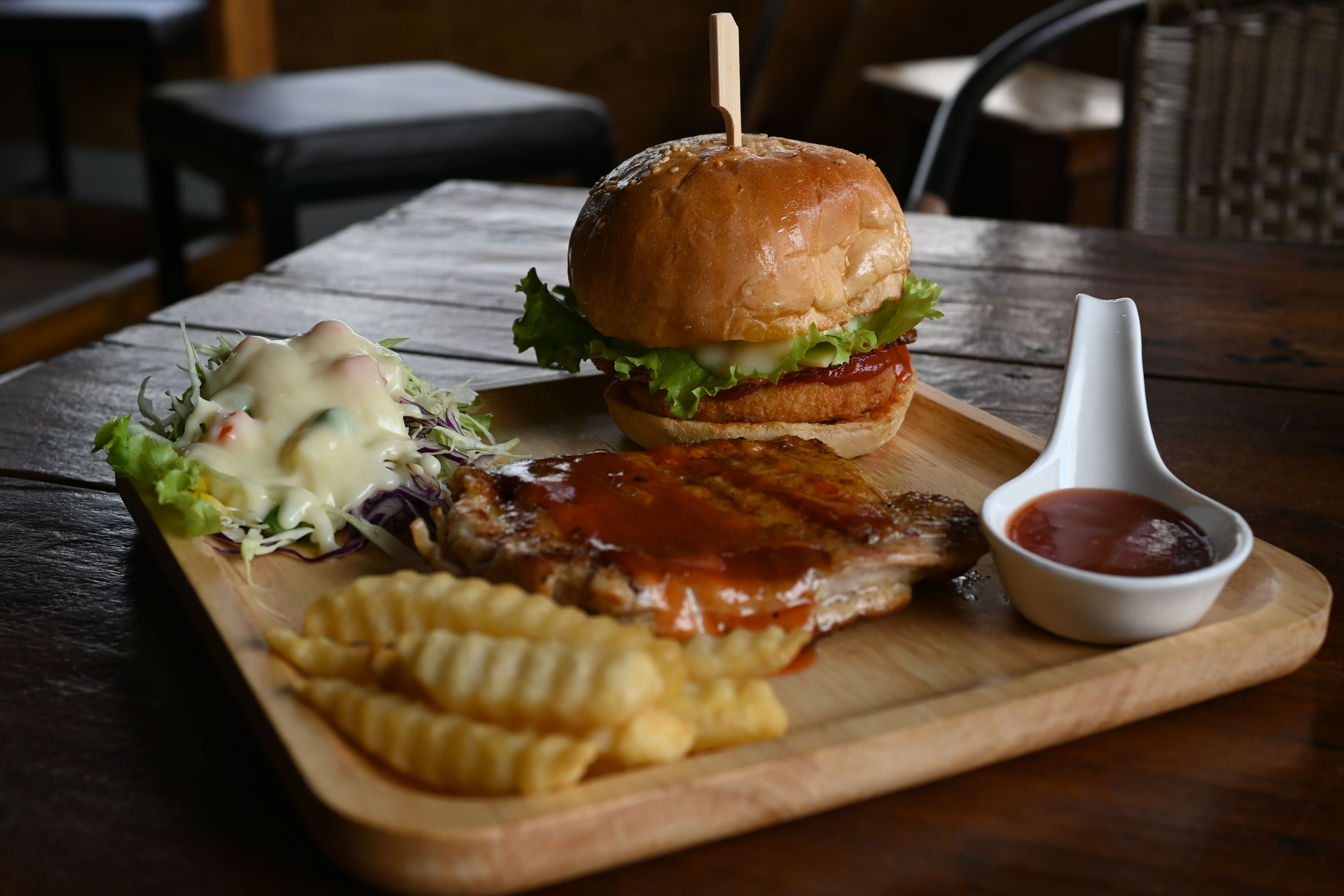 A restaurant cheeseburger served with French fries.