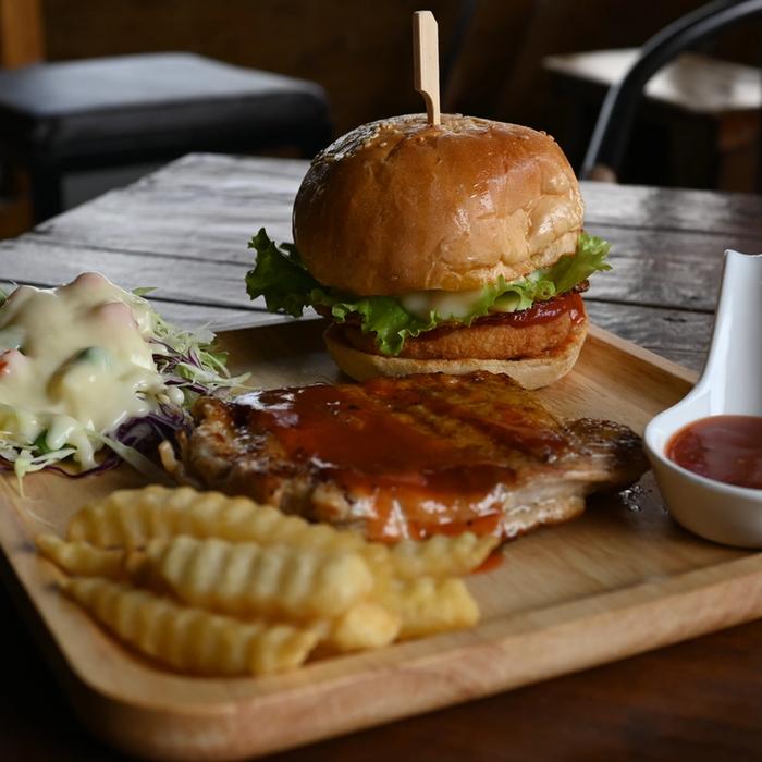 A restaurant cheeseburger served with French fries.
