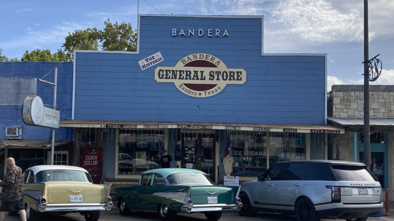 The historic Bandera General Store with vintage cars parked out front.