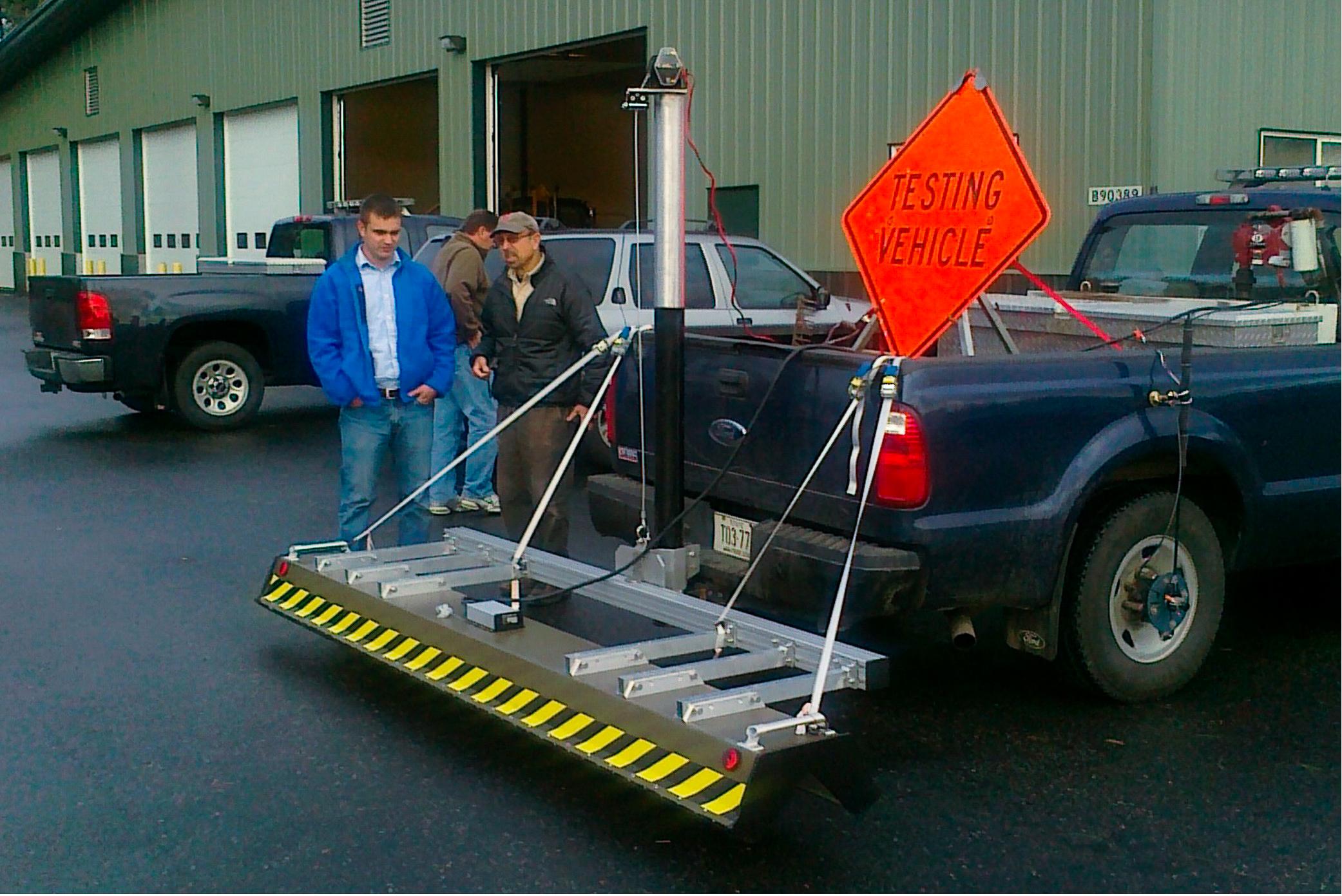 People behind a car wit a sensor