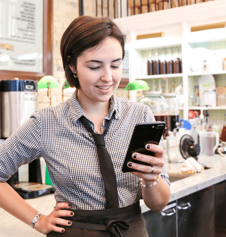 Image of employee checking their work schedule on their phone