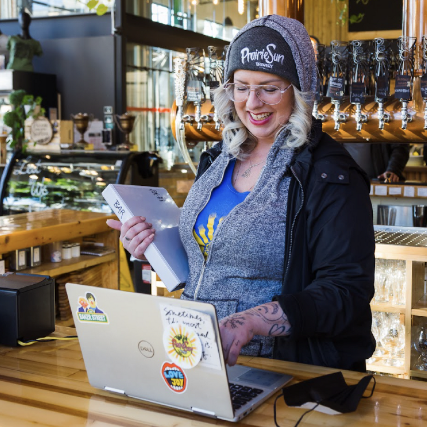 Happy restaurant employee using team management software