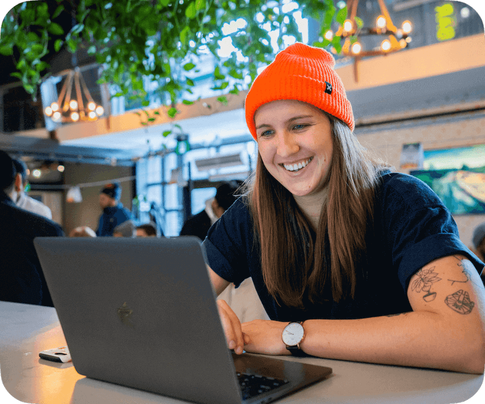 Happy restaurant manager using workforce management on the computer.