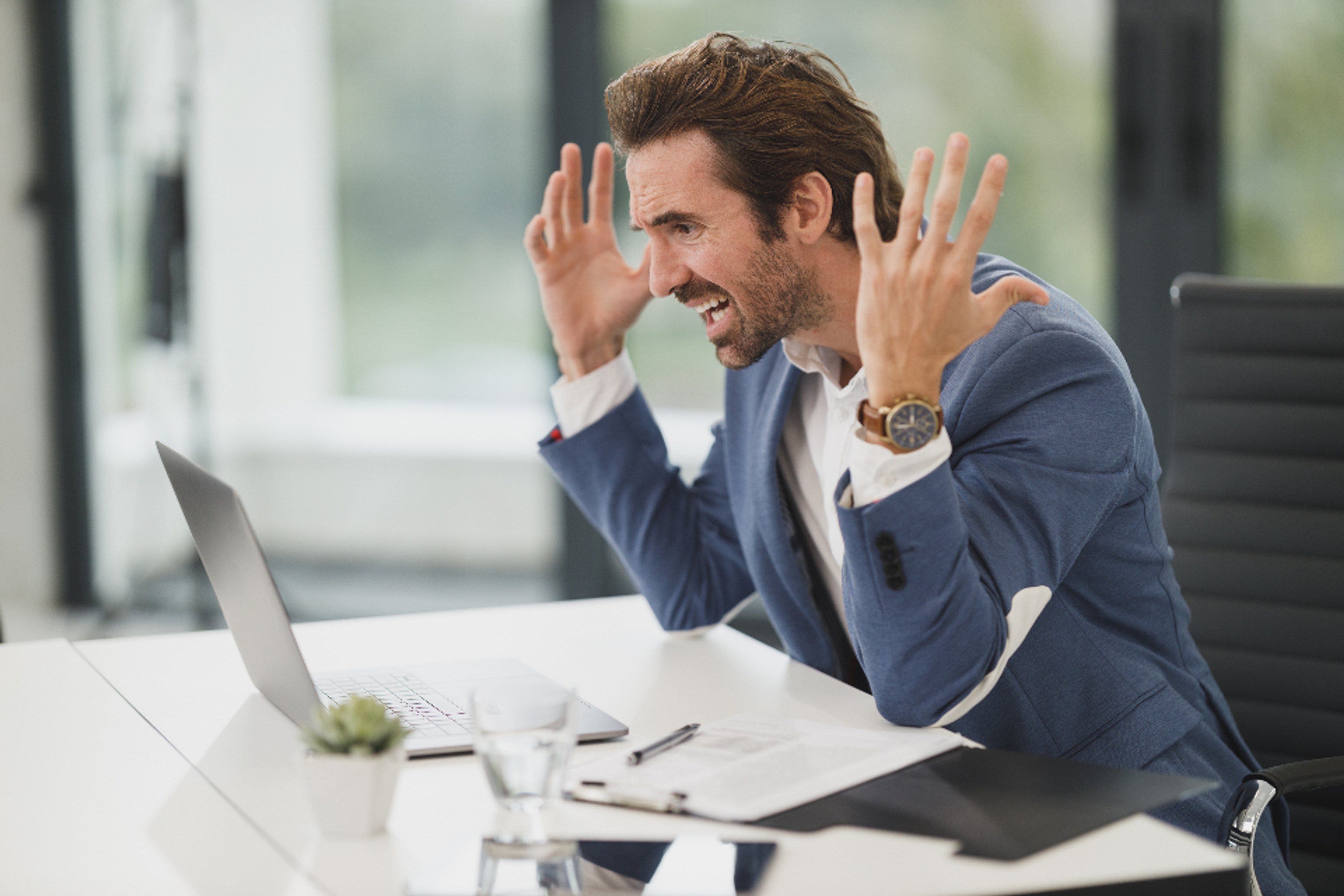 IT professional using a laptop during a remote support and review meeting
