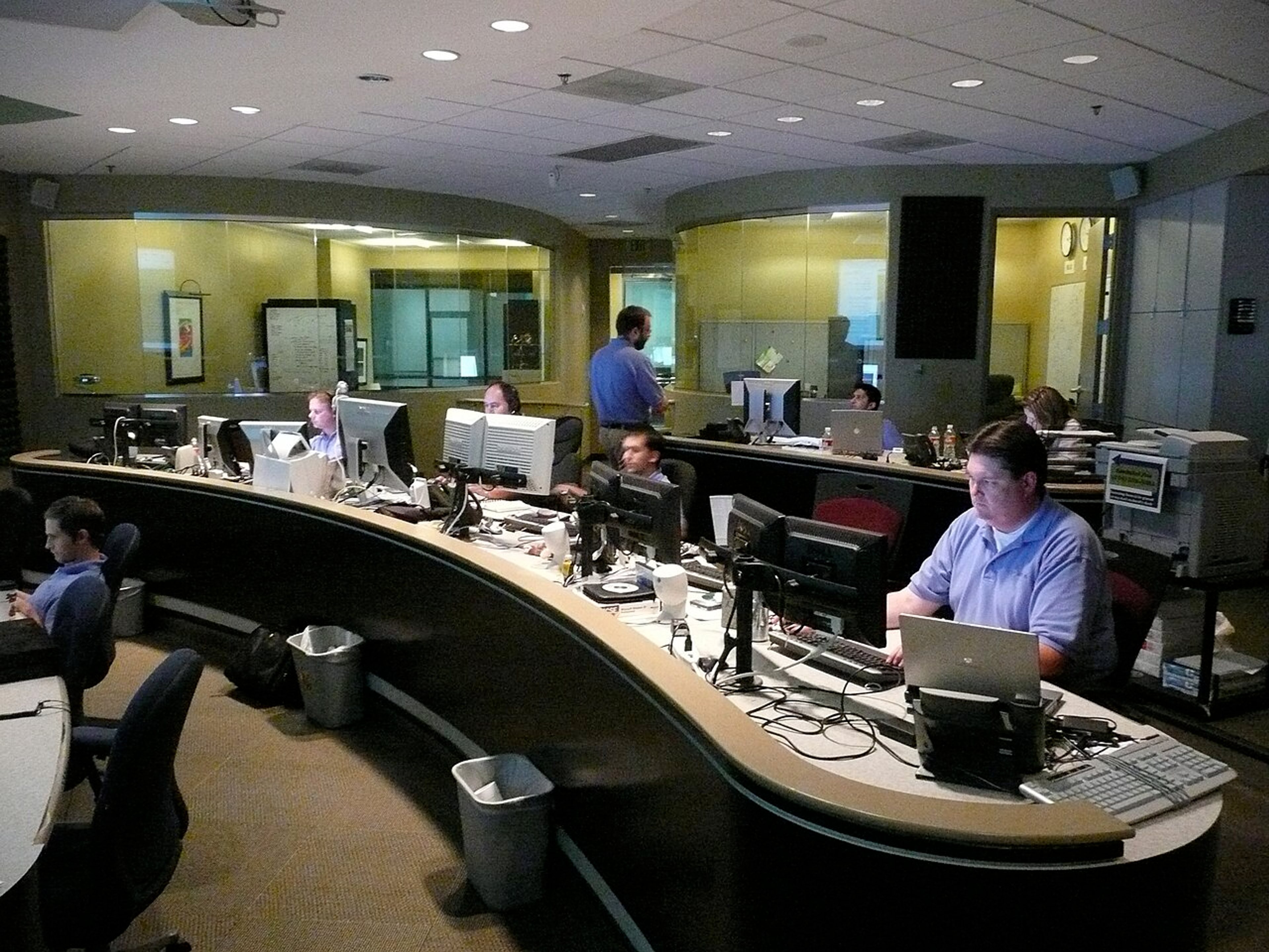 IT support team monitoring workstations in a commercial network operations center