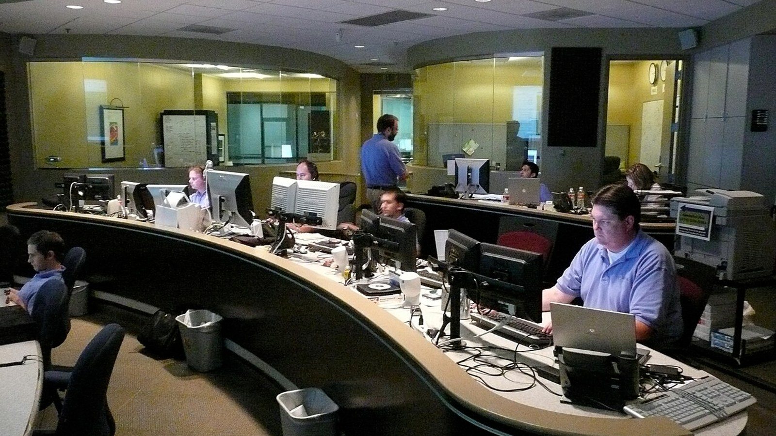 IT operations staff monitoring endpoint health and device management workflows across multiple screens