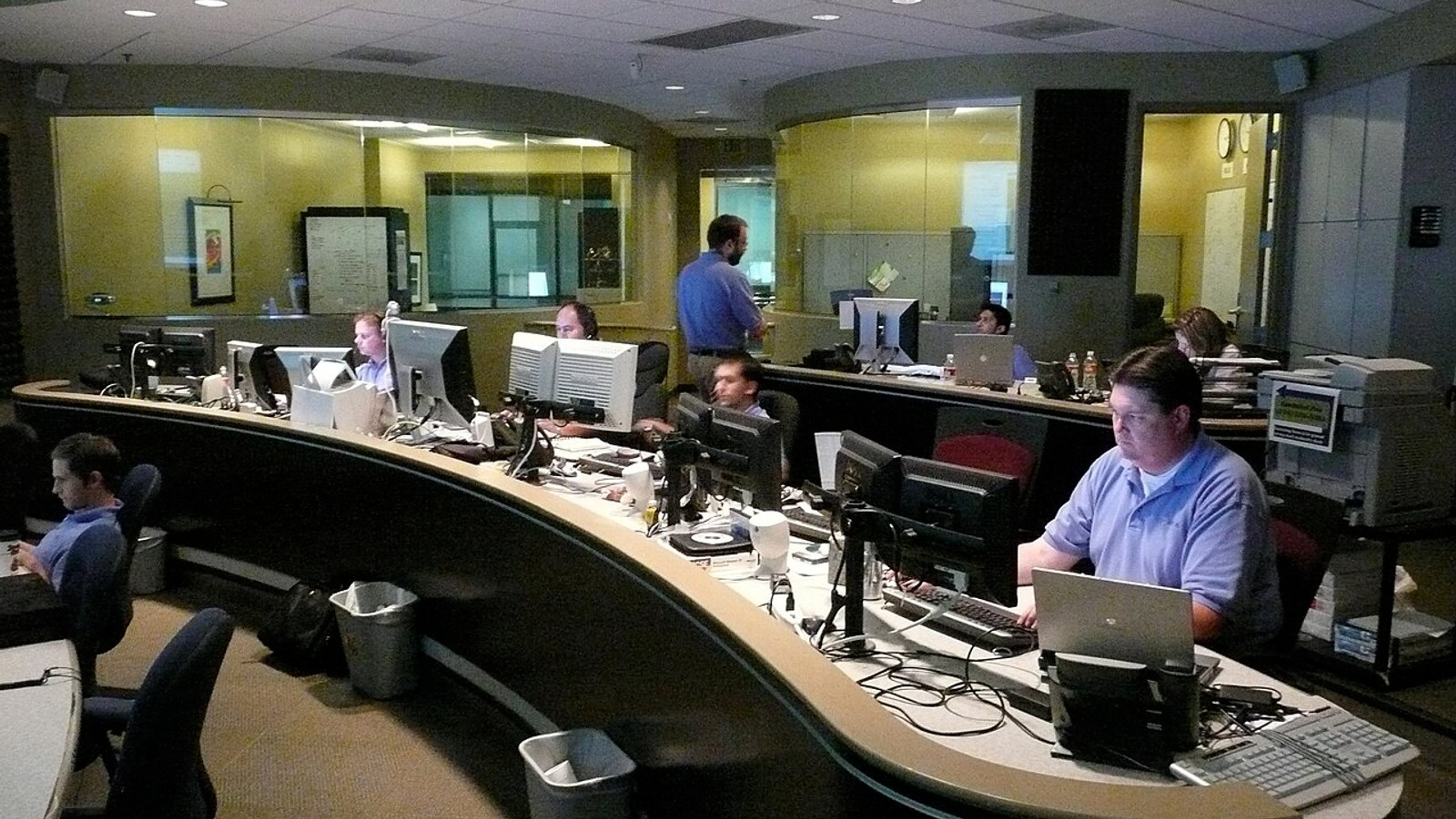 IT operations staff monitoring endpoint health and device management workflows across multiple screens