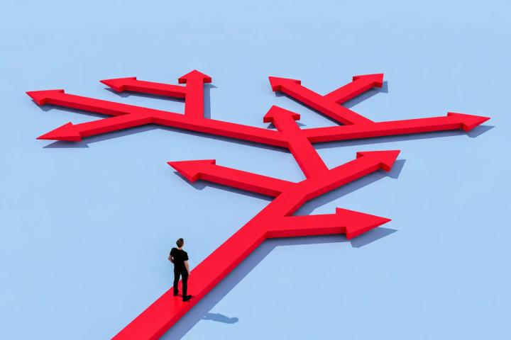Person standing at a crossroads of arrows representing decision-making and decision rights