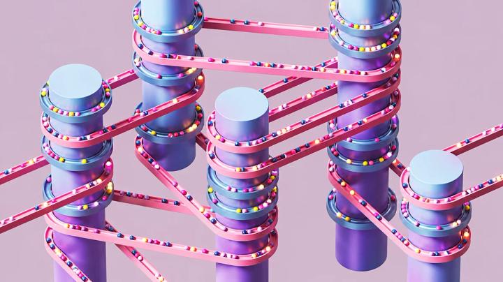 Abstract illustration of colourful beads moving along interconnected pink tracks around blue and purple cylinders