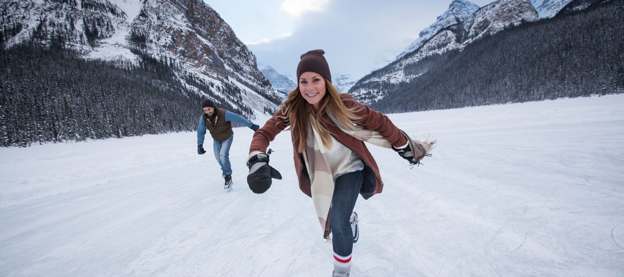 A women skates on Lake Louise, Banff National Park, AB