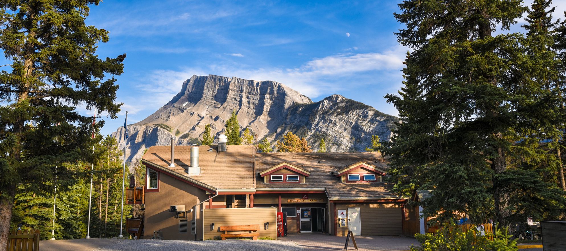 Exterior of the HI Banff Alpine Centre with Mount Rundle in the background