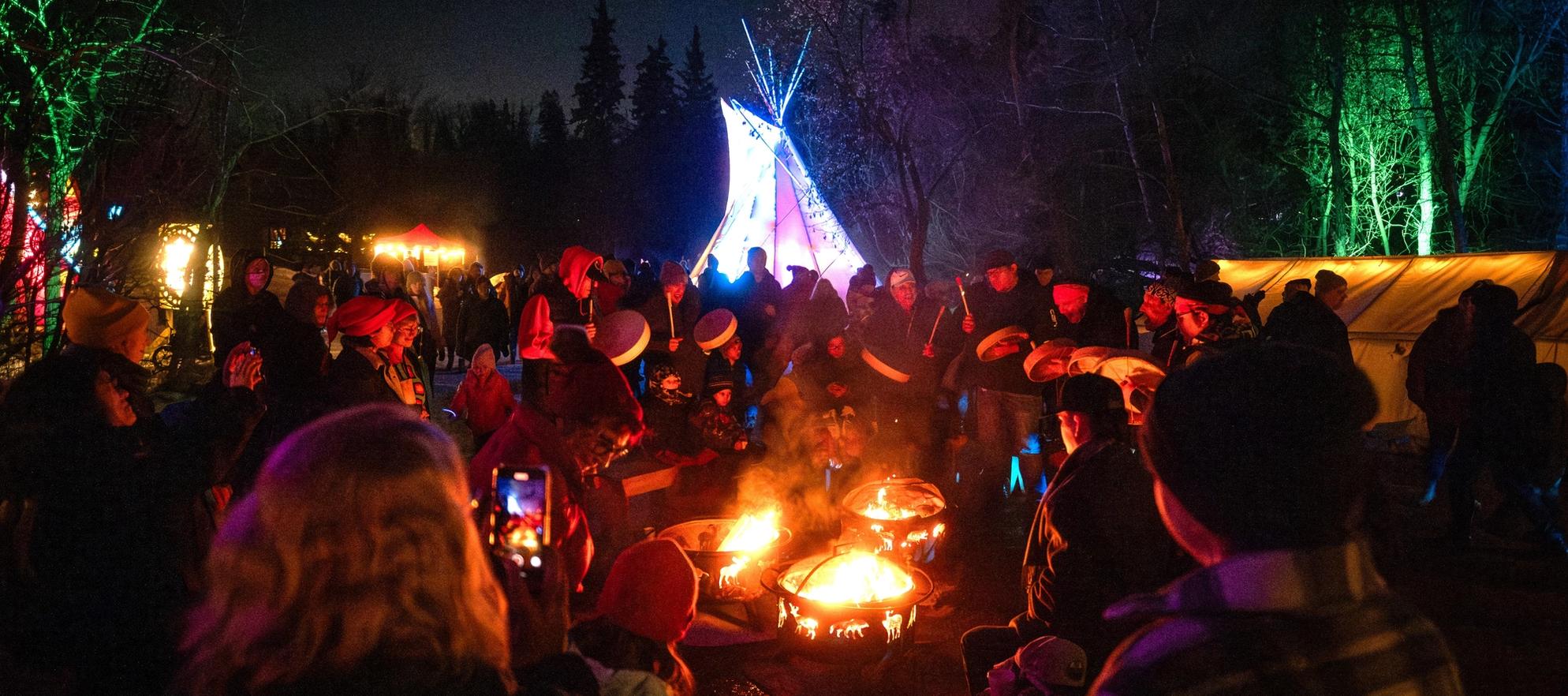 People engaging in an Indigenous cultural display at the Flying Canoe Volante festival.