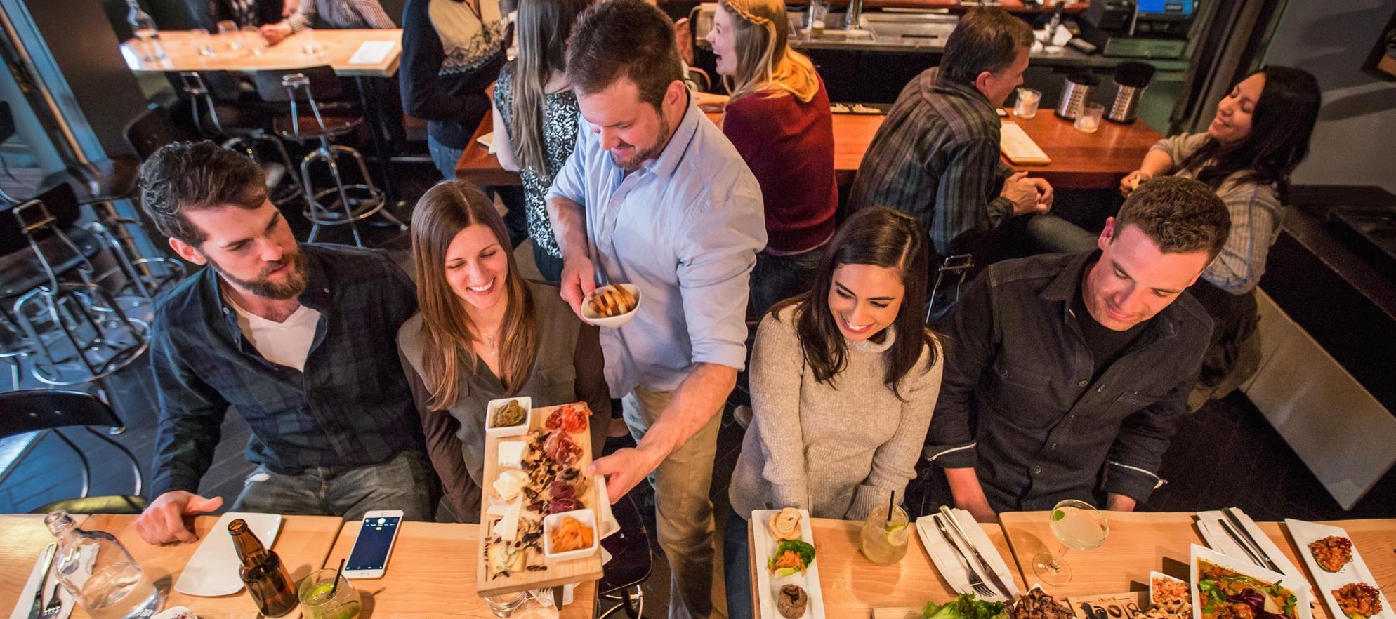 Two couples go on a date at the Block Restaurant in Banff during the winter.