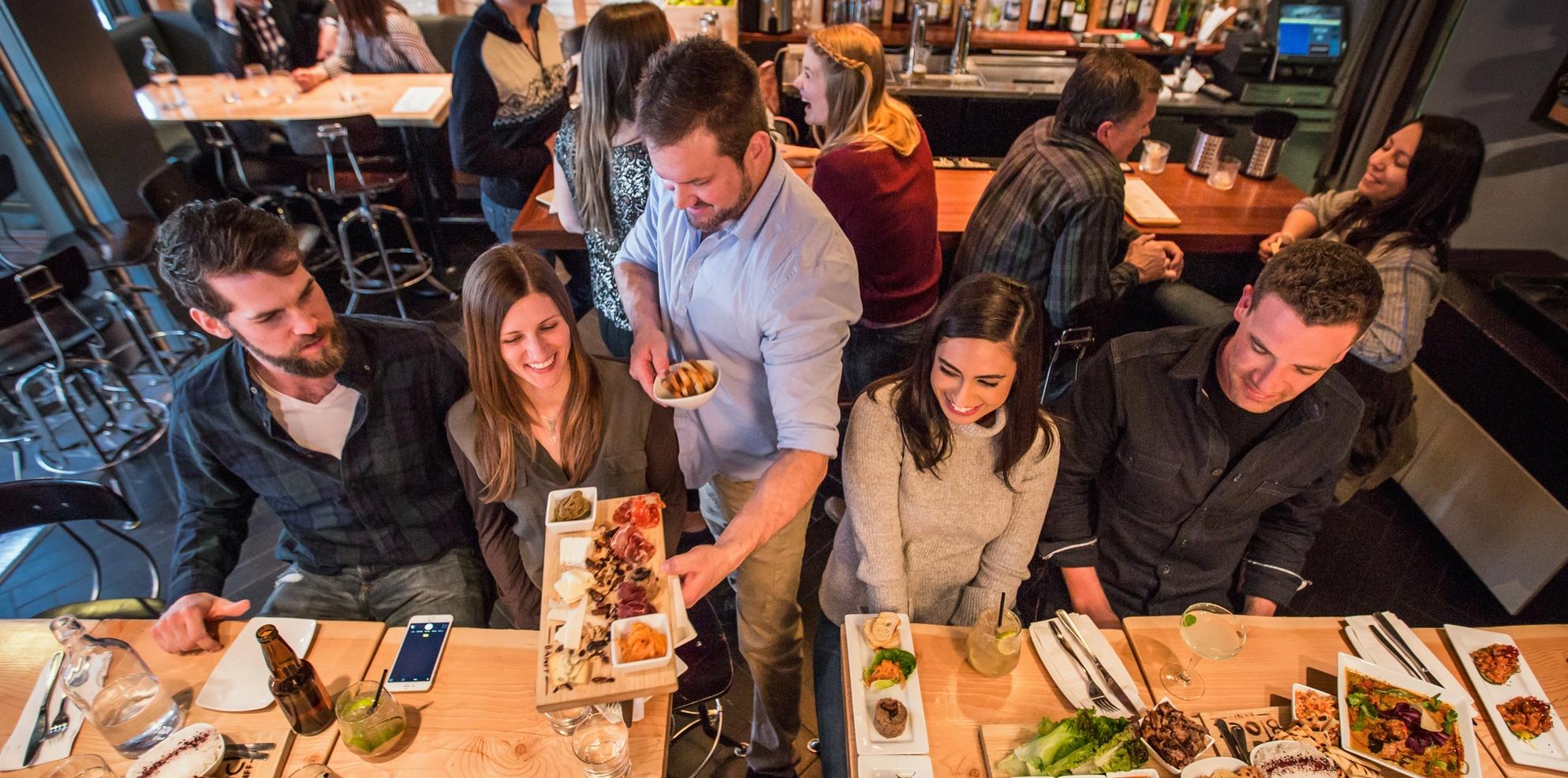 Two couples go on a date at the Block Restaurant in Banff during the winter.
