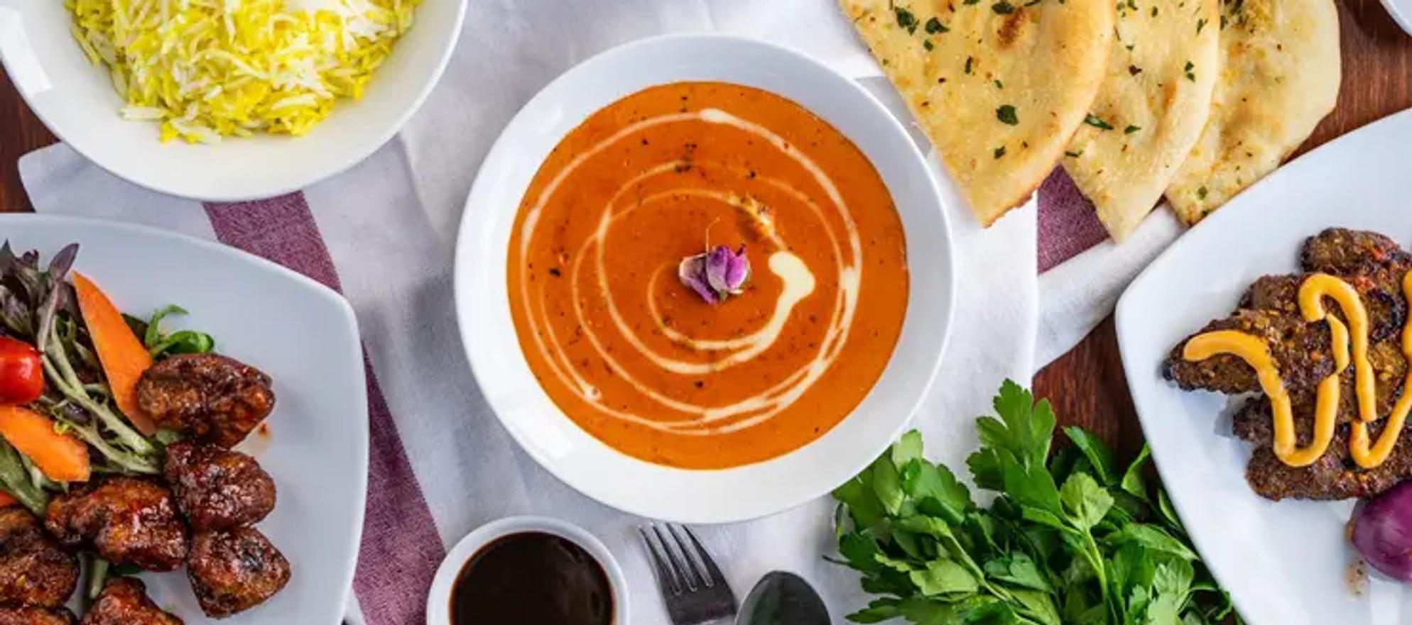 A spread of asian-indian foods on a dining table
