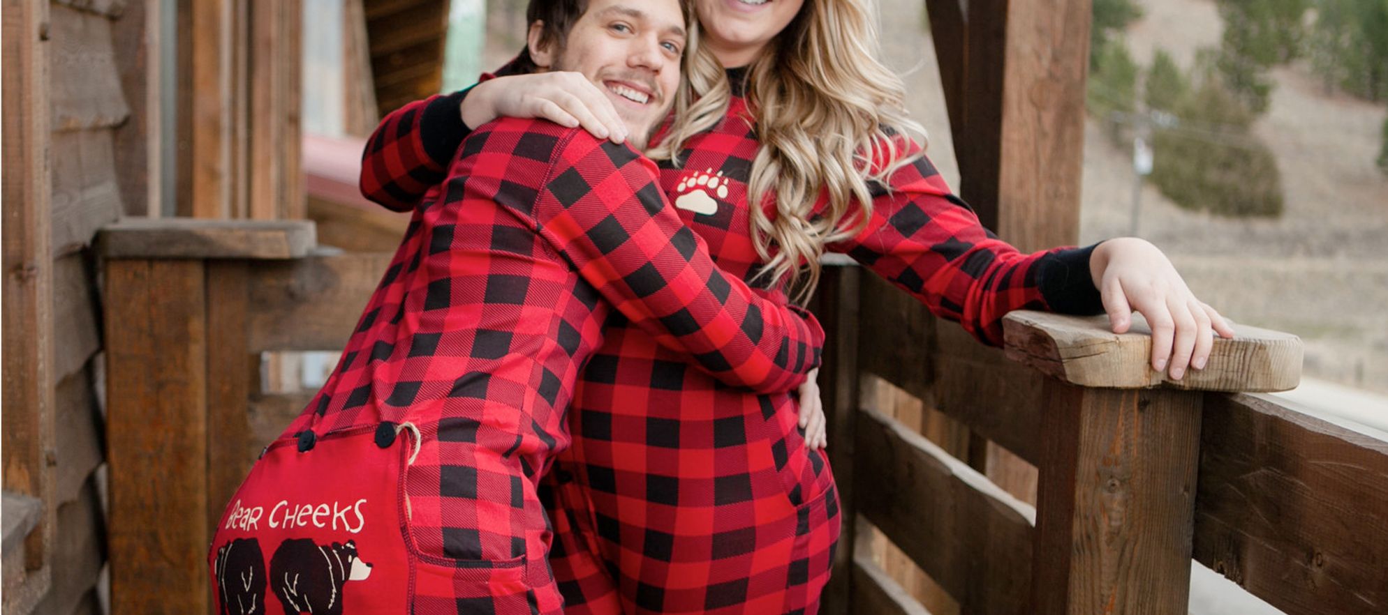a couple wearing matching red flannel pajamas