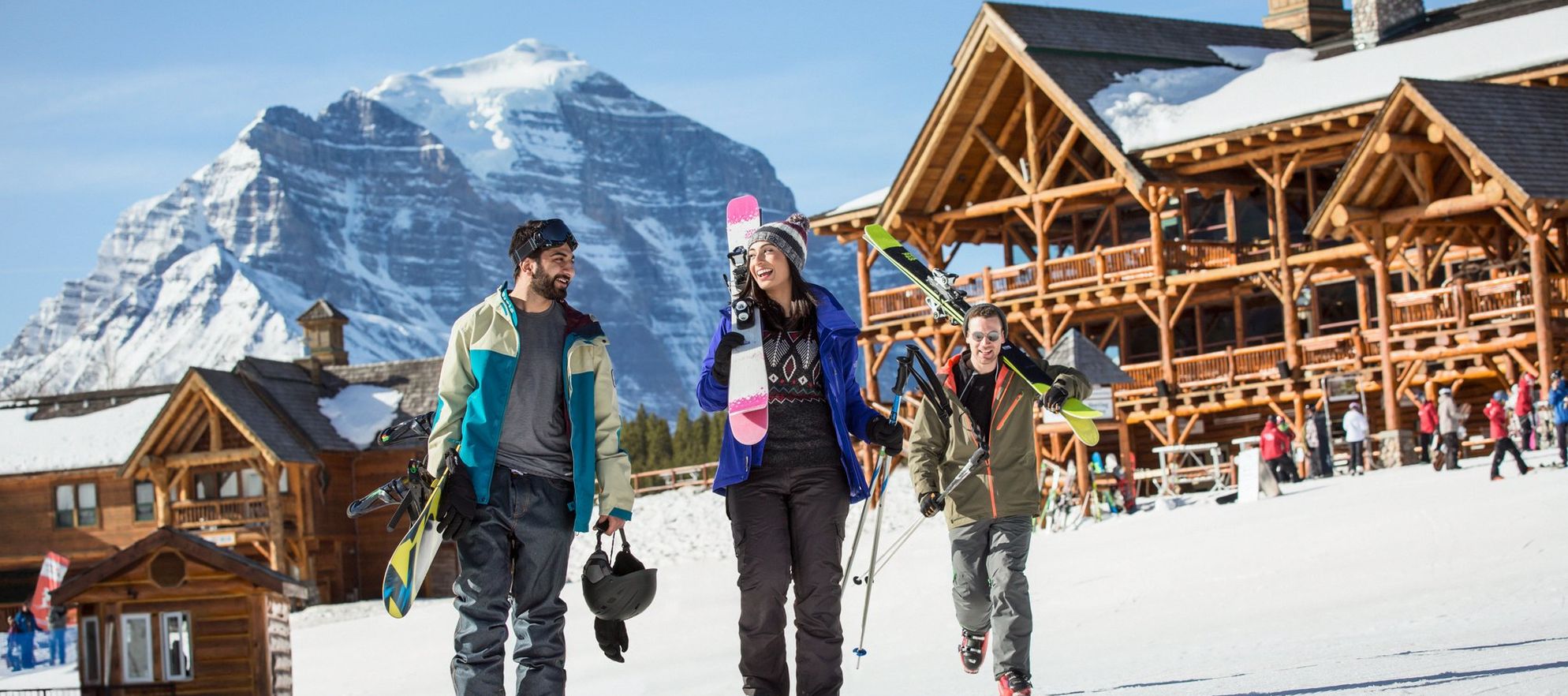 Friends at a ski resort heading toward the chairlift with all their gear