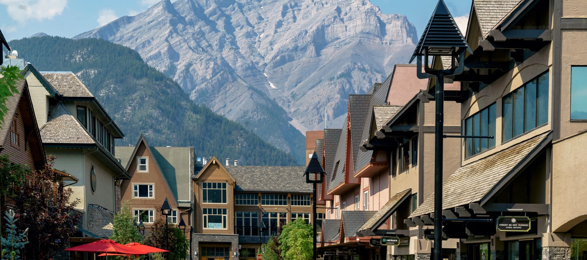 People walk on the new Bear Street in Banff with Cascade Mountain in the background.