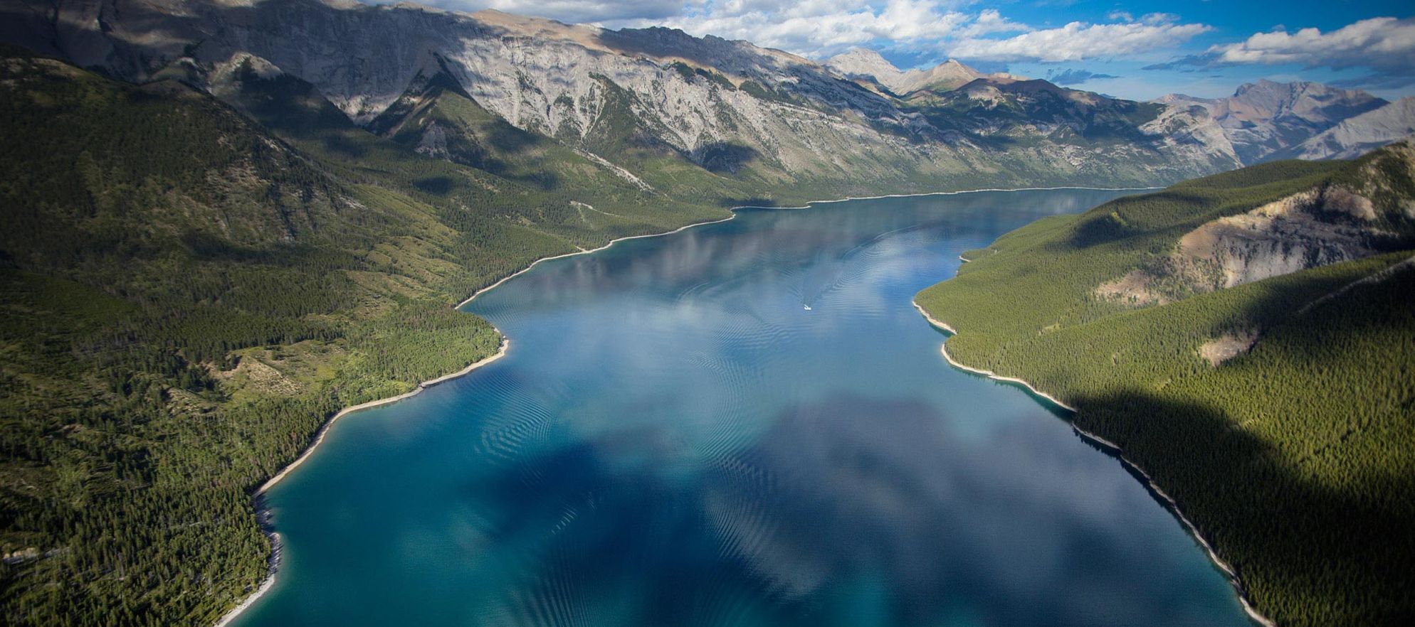 Just outside of the town Banff, Lake Minnewanka is a popular place for hiking, biking, fishing, canoeing, and swimming in Banff National Park.