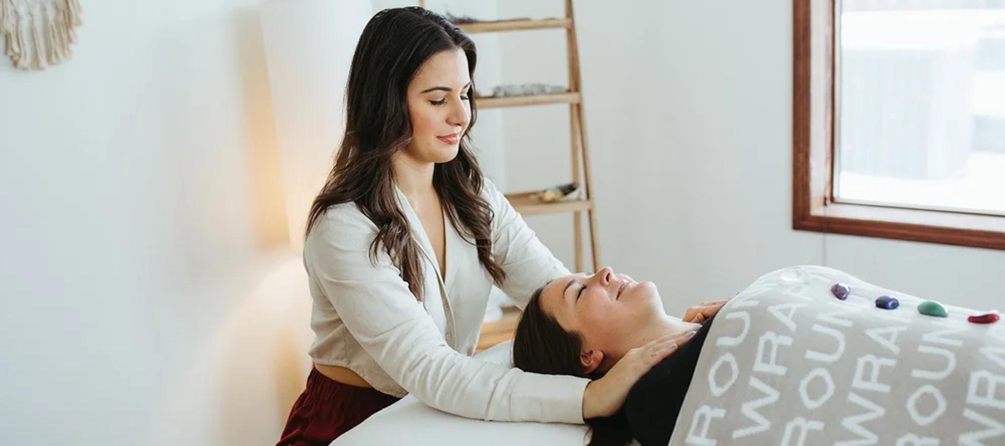 A person conducting reiki energy healing on a client in Banff with Medium in the Middle