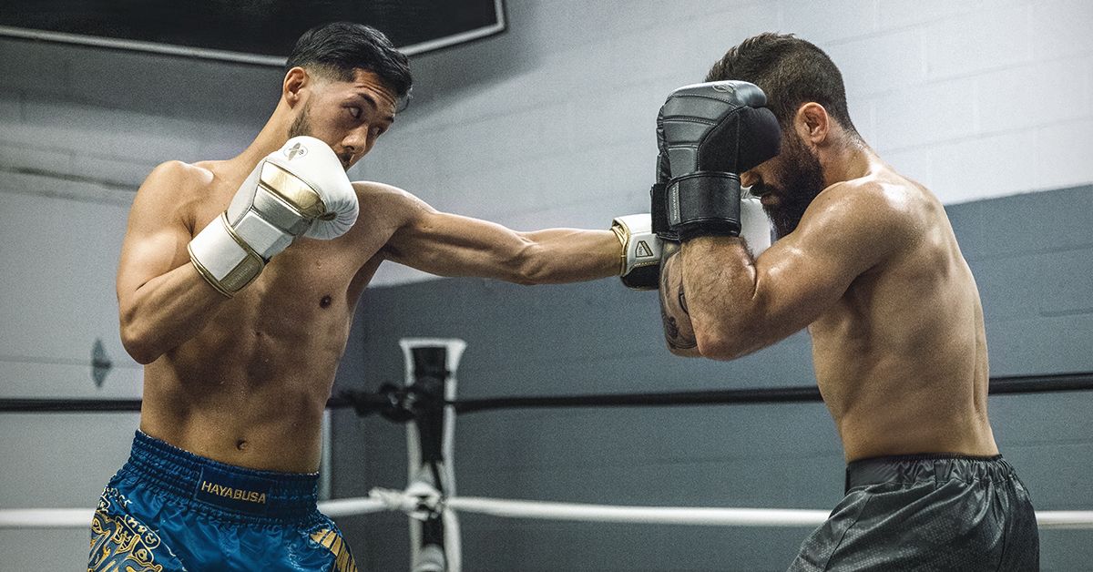 Two Men Building Muscle with Heavy Bag Training