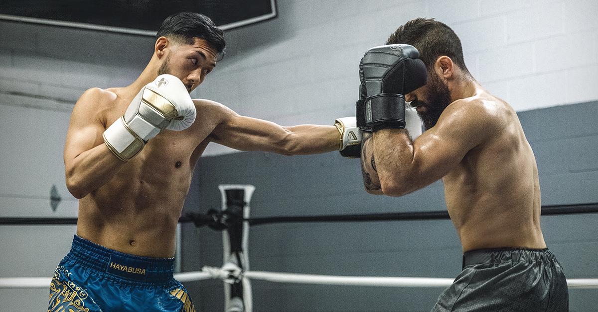 Two Men Building Muscle with Heavy Bag Training
