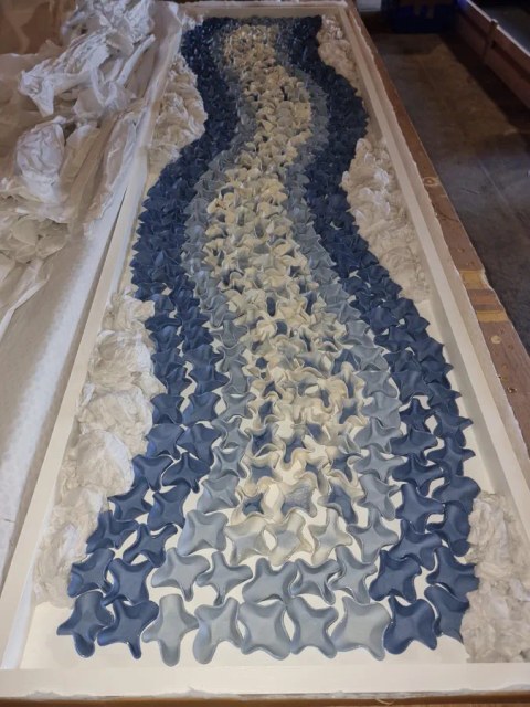 Ceramic art panel packed flat and protected inside a crate