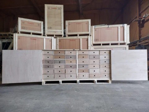 Finished custom crates stacked in the workshop