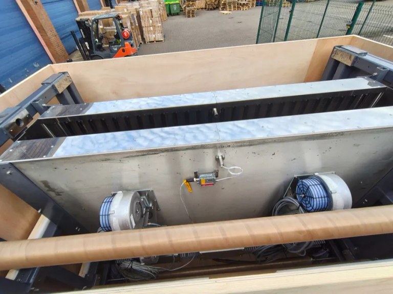 Large fabricated ductwork braced inside a timber crate