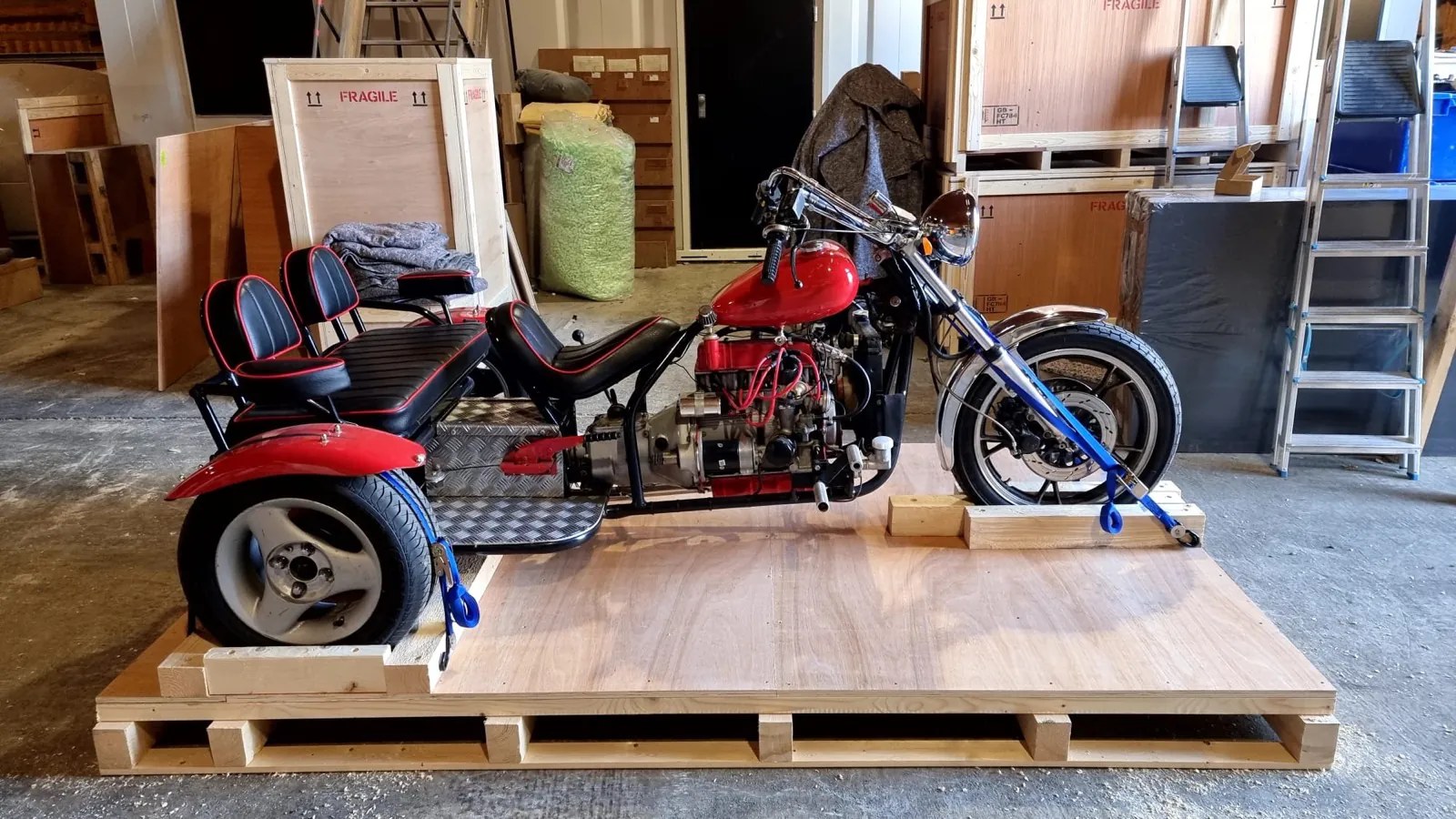 Motorcycle trike on a custom crate base in the workshop