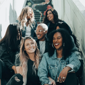 7 smiling women sitting on some steps