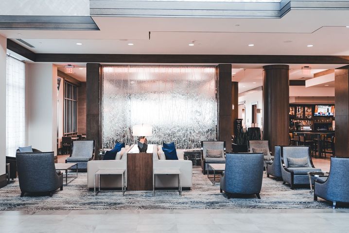 A bright, modern hotel lobby where a group would check in against its room block