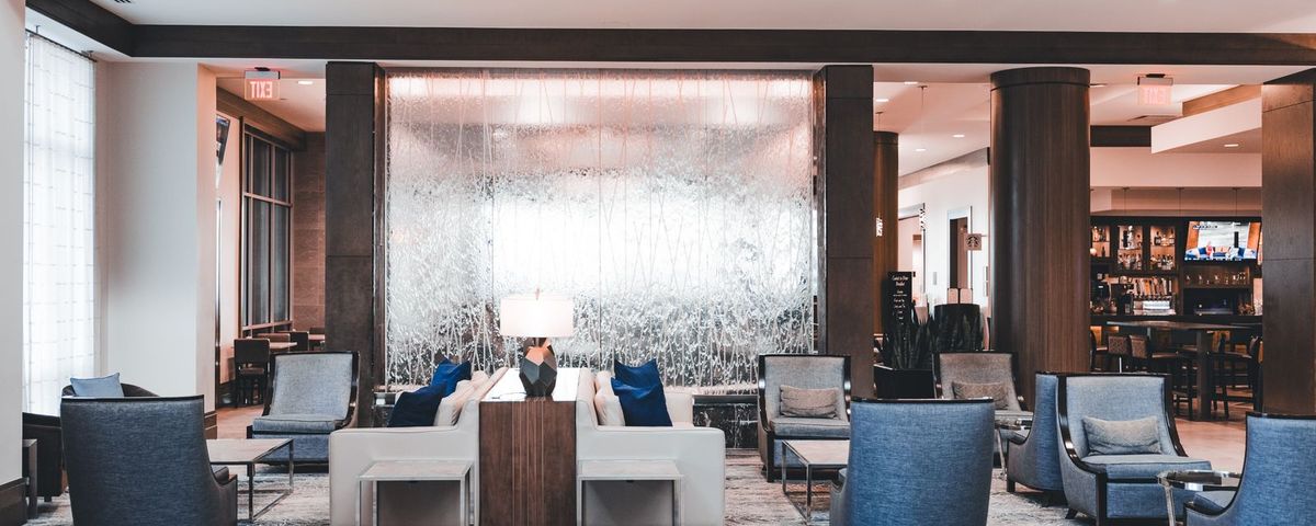 A bright, modern hotel lobby where a group would check in against its room block