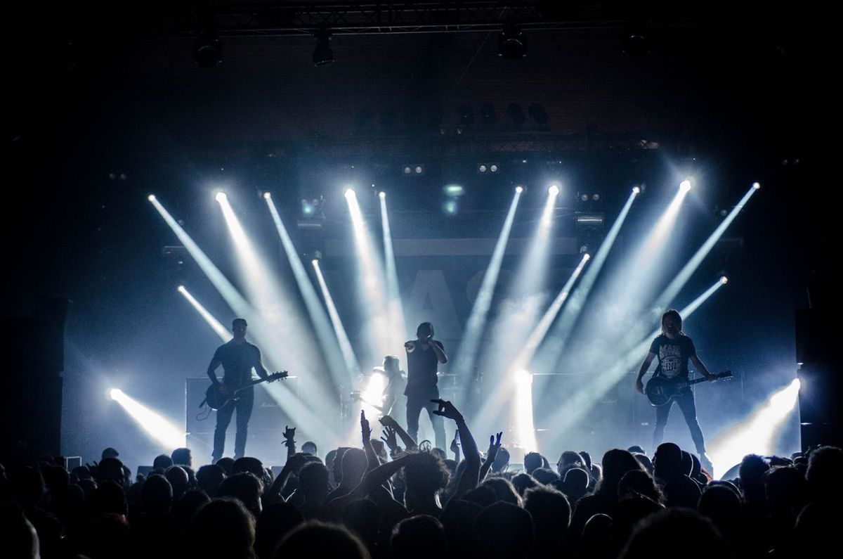 Energetic live concert with musicians performing on stage.
