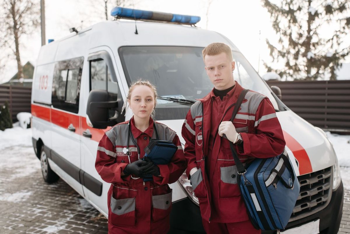 Emergency responders standing in front of an ambulance.