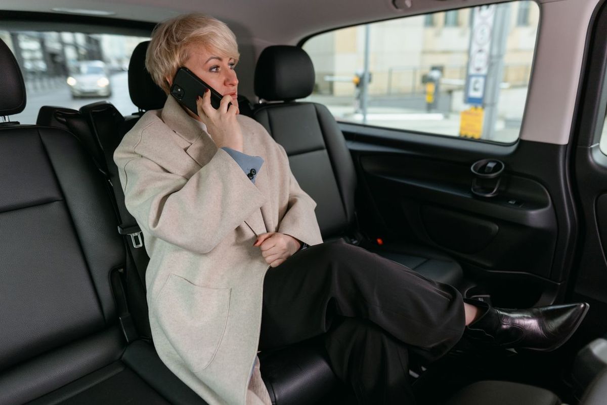 Woman in a car making phone call.