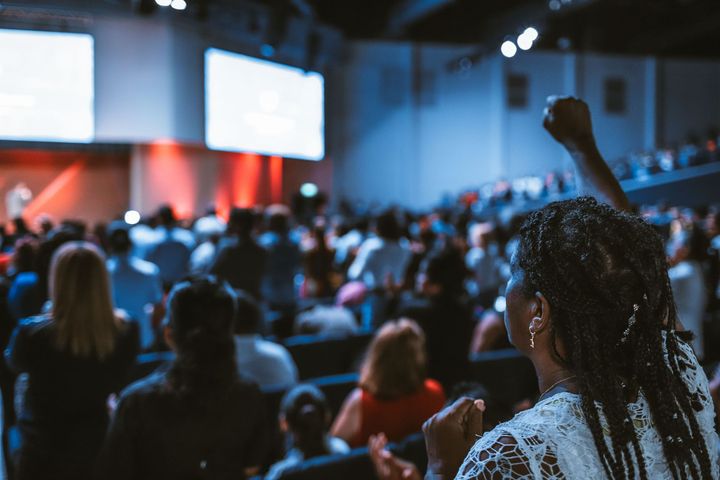 A packed conference session, the kind of event that fills hotel room blocks