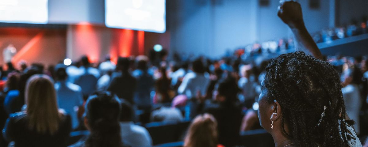 A packed conference session, the kind of event that fills hotel room blocks