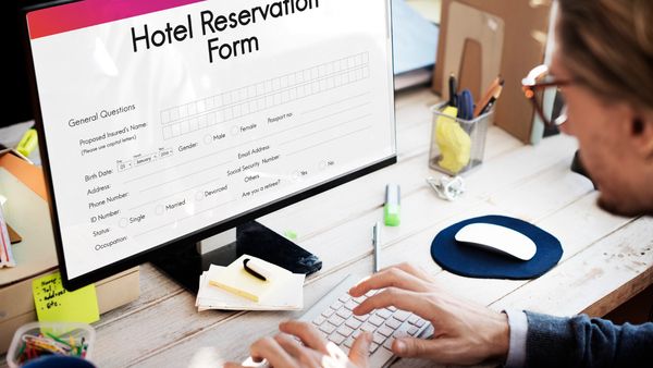Should we reserve fewer rooms upfront and add more later, or book the full estimated amount from the start?