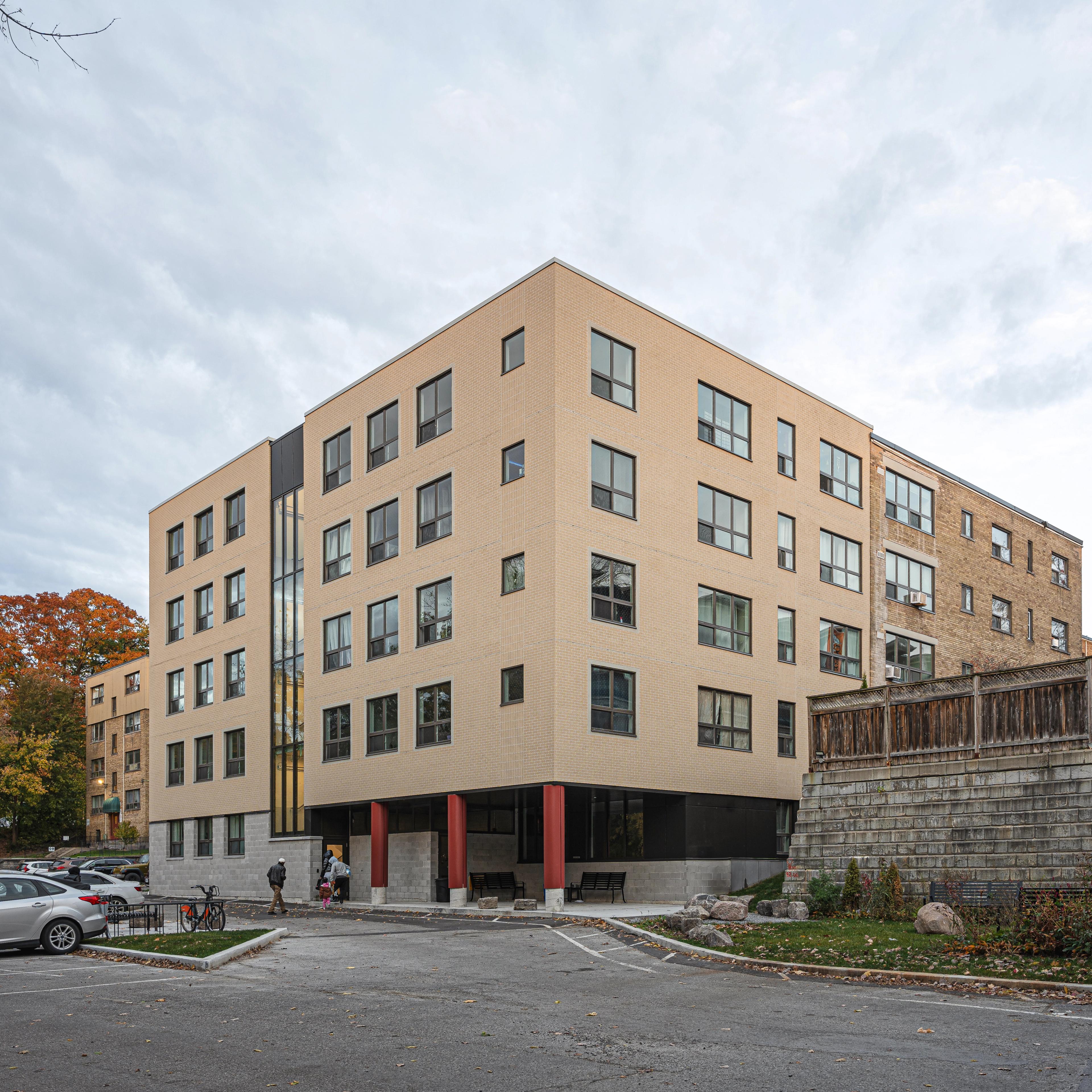 Exterior daytime view showing the existing building and new addition