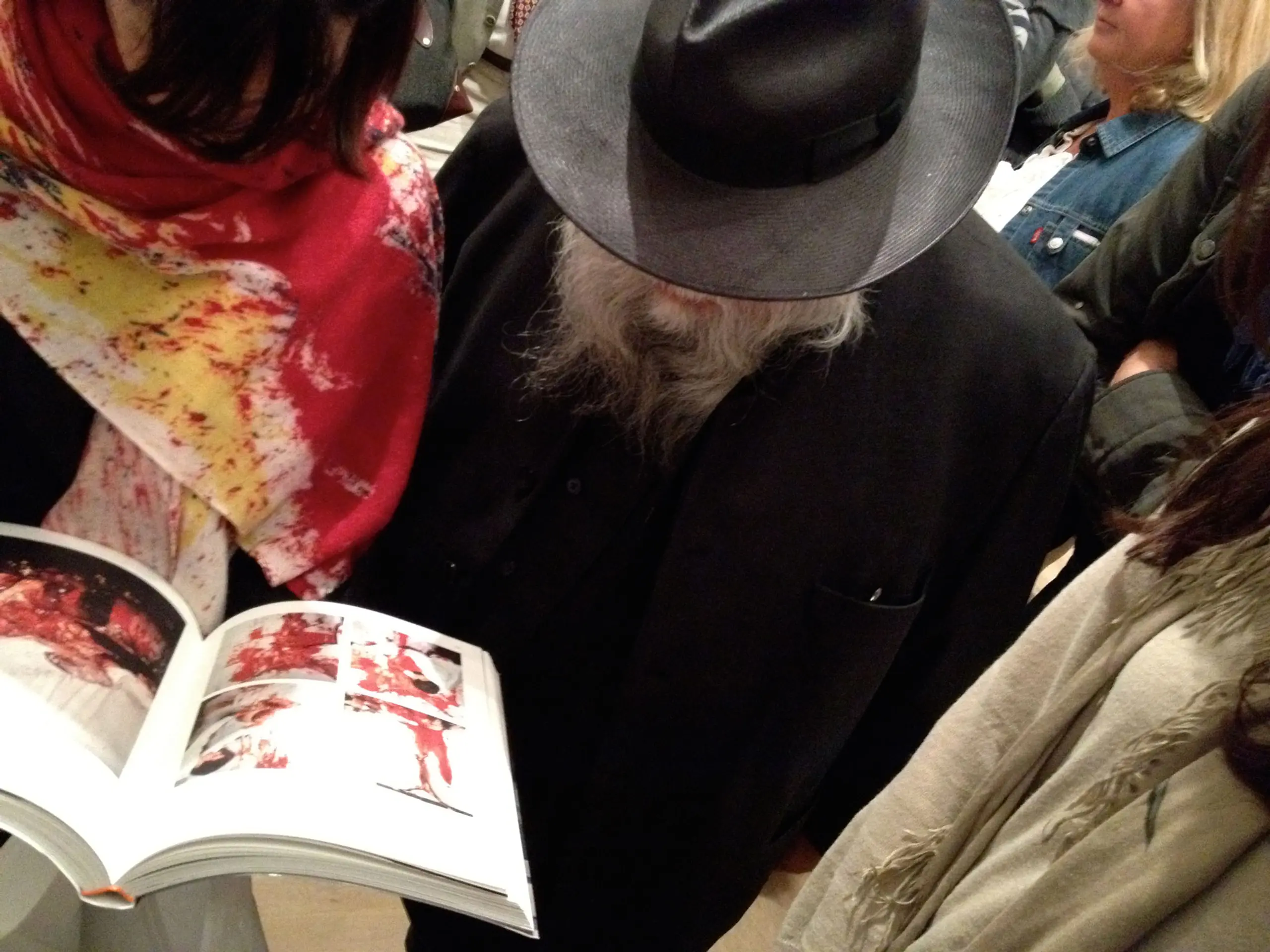 Hermann Nitsch flipping through the SDL designed Explosion! catalogue
