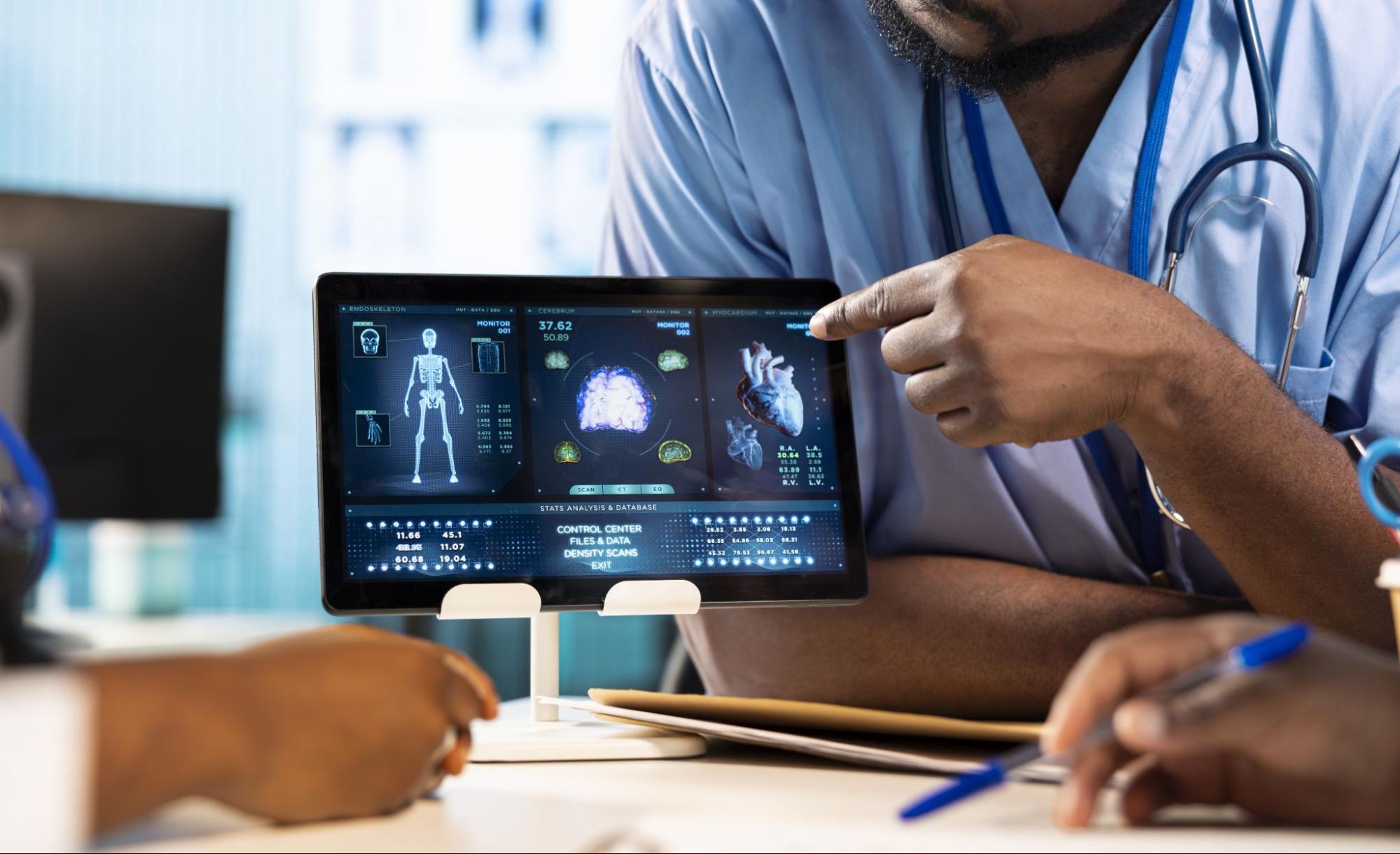 A doctor examines a medical image displayed on a tablet, focusing intently on the screen.