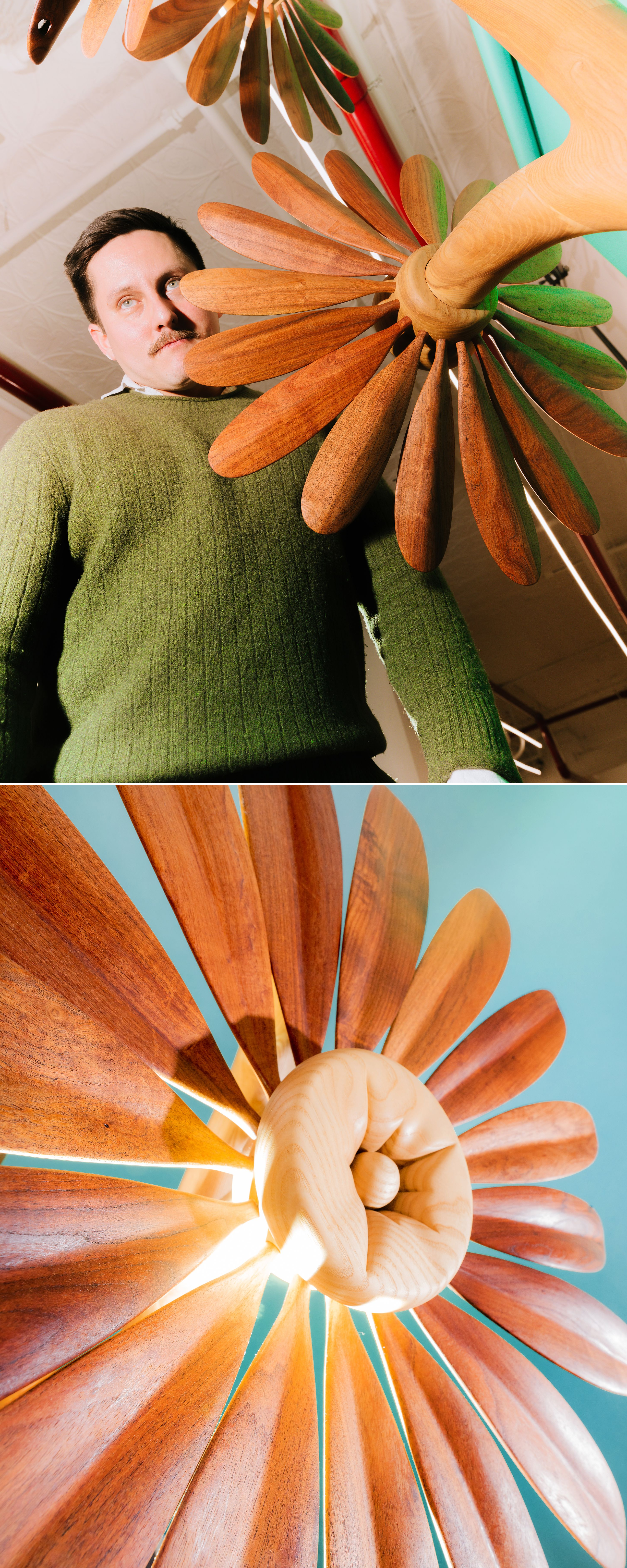 Two photos of a large wooden flower sculpture with long carved petals radiating from a spiral center. In one, a man with a moustache in an olive green sweater stands beside it under a white ceiling, gazing into the distance. In the other, the sculpture is shown from below against a teal backdrop, its petals fanning outward.
