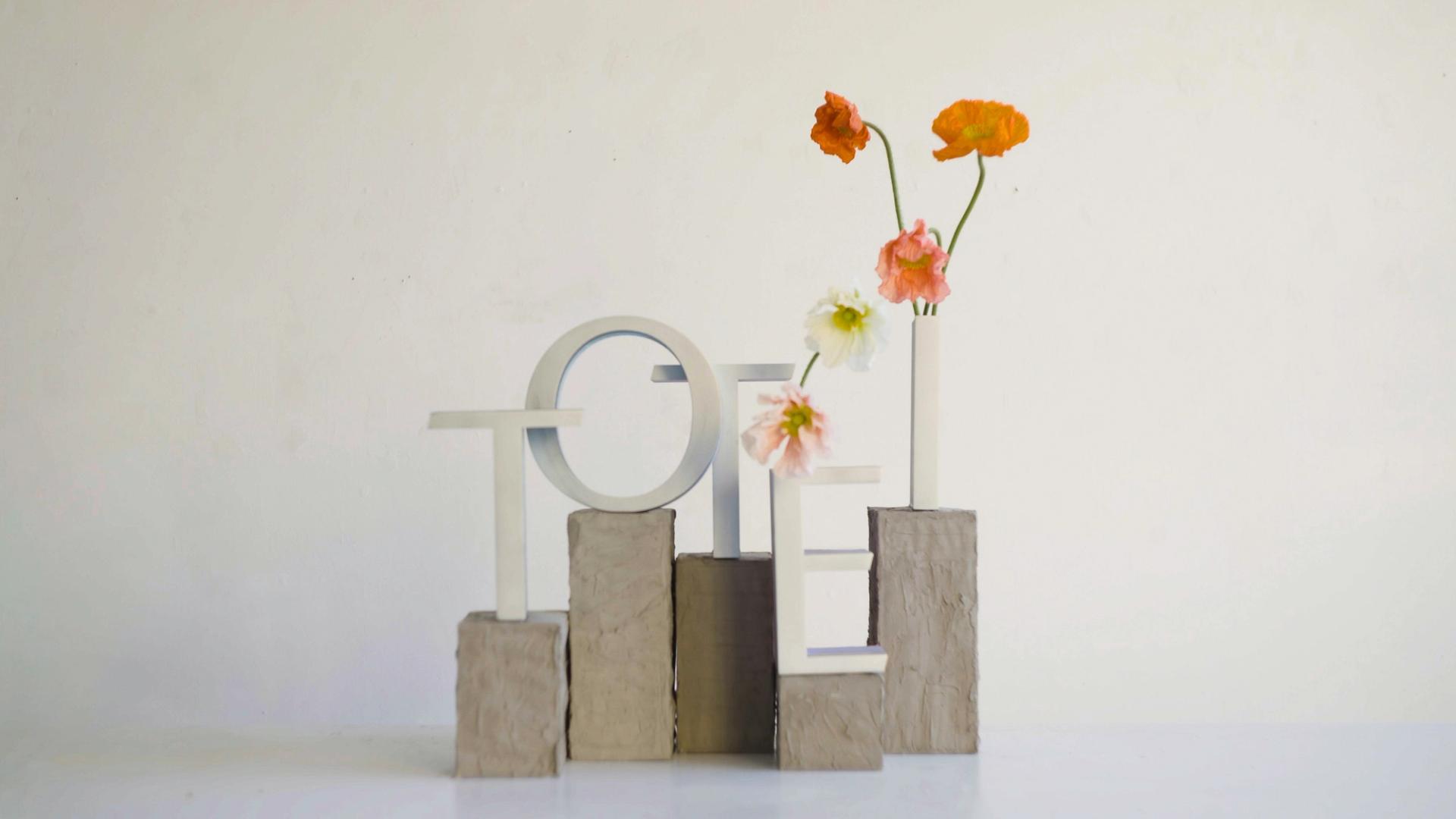 The word Totei with flowers coming out of the letters