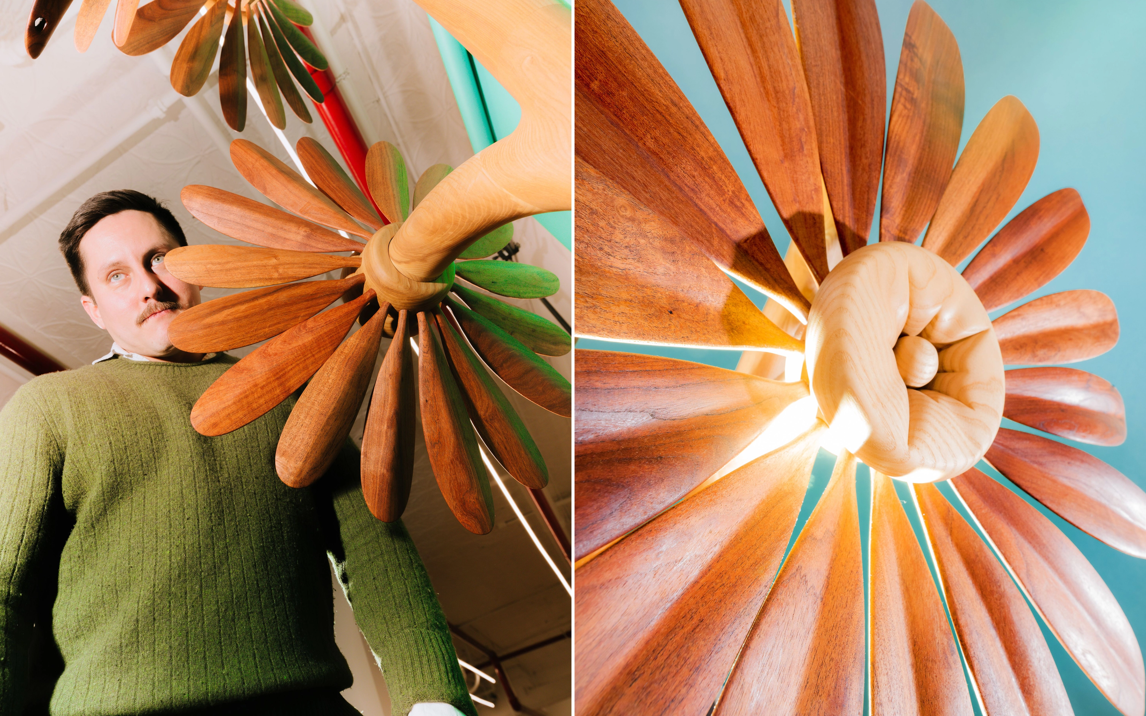 Two photos of a large wooden flower sculpture with long carved petals radiating from a spiral center. In one, a man with a moustache in an olive green sweater stands beside it under a white ceiling, gazing into the distance. In the other, the sculpture is shown from below against a teal backdrop, its petals fanning outward.