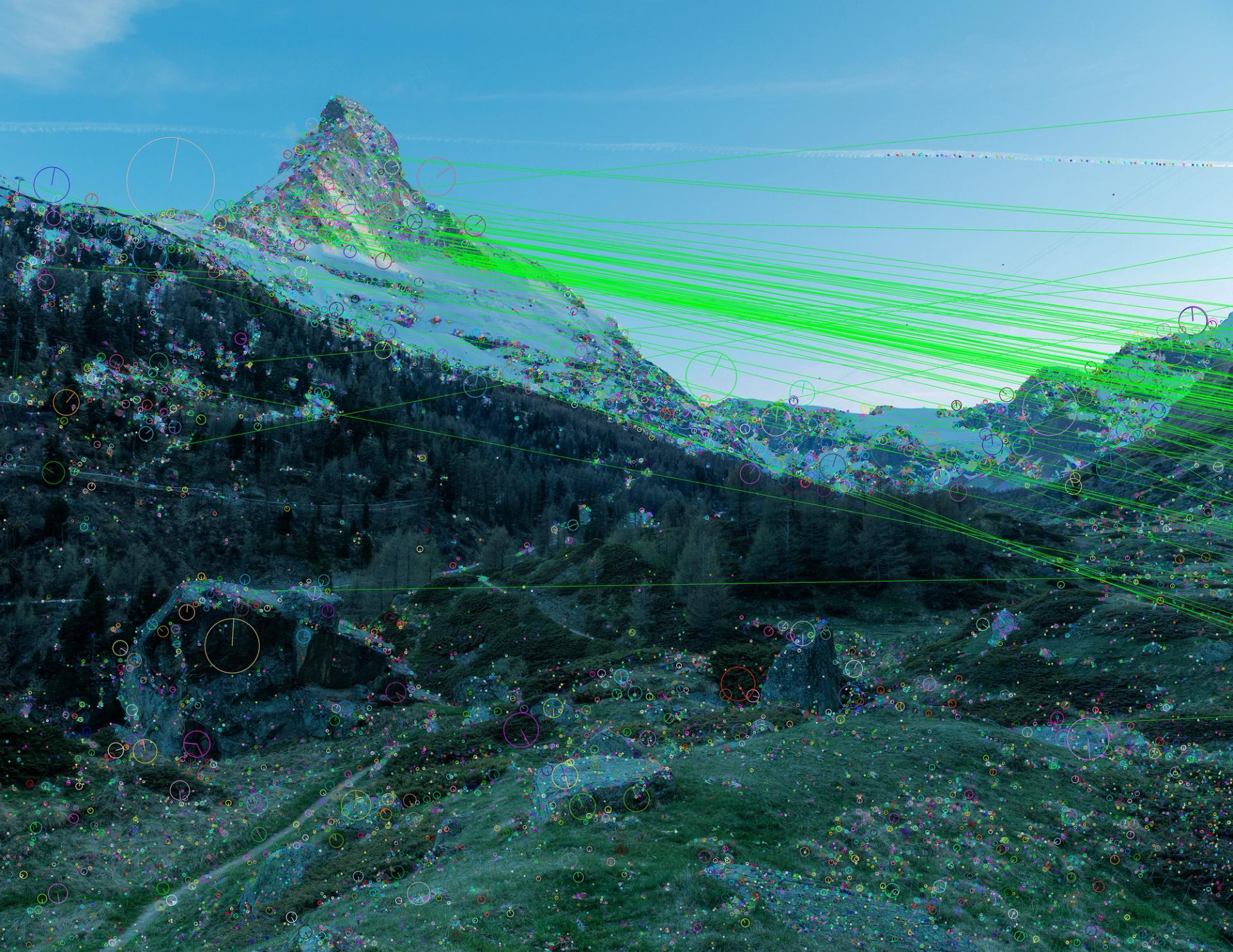 A mountain landscape overlaid with digital data visualization: bright green lines radiate across the scene, with scattered multicolored circles and markers mapping points across the terrain.