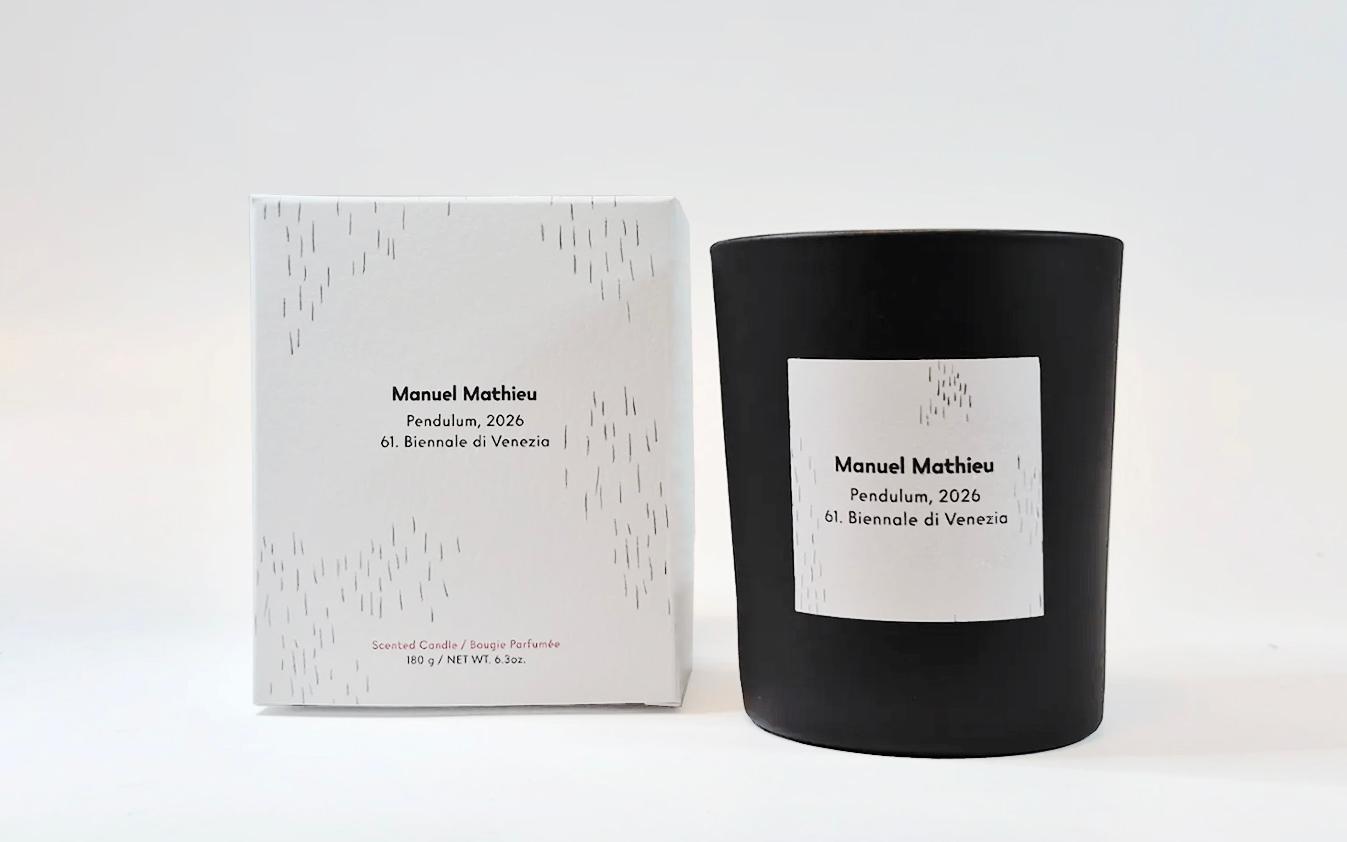 Black glass candle and white box labeled “Manuel Mathieu, Pendulum, 2026, 61. Biennale di Venezia,” with minimalist black line pattern.