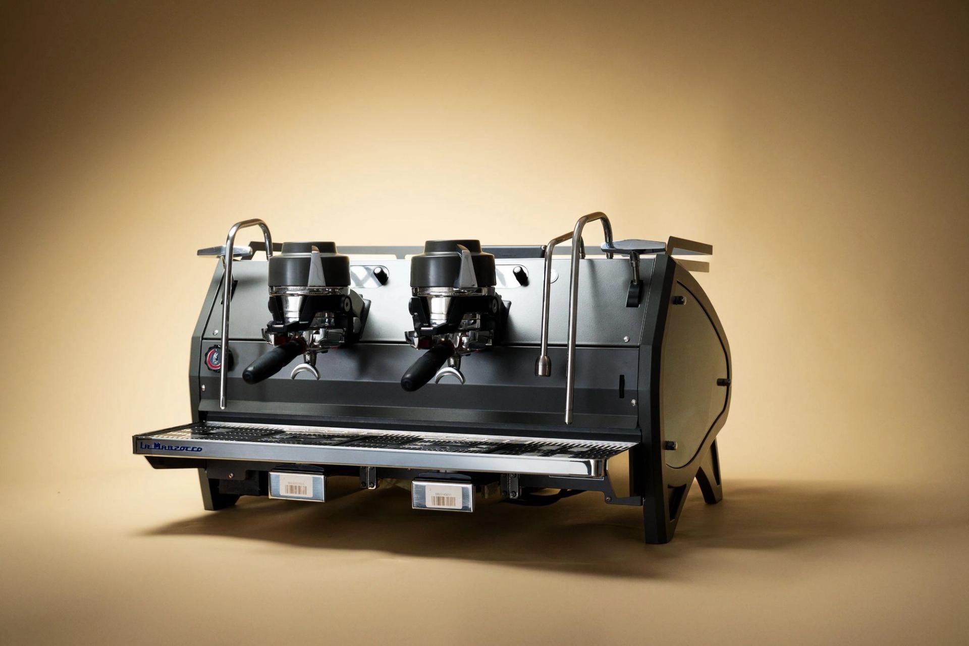 Espresso machine against a warm gradient background.