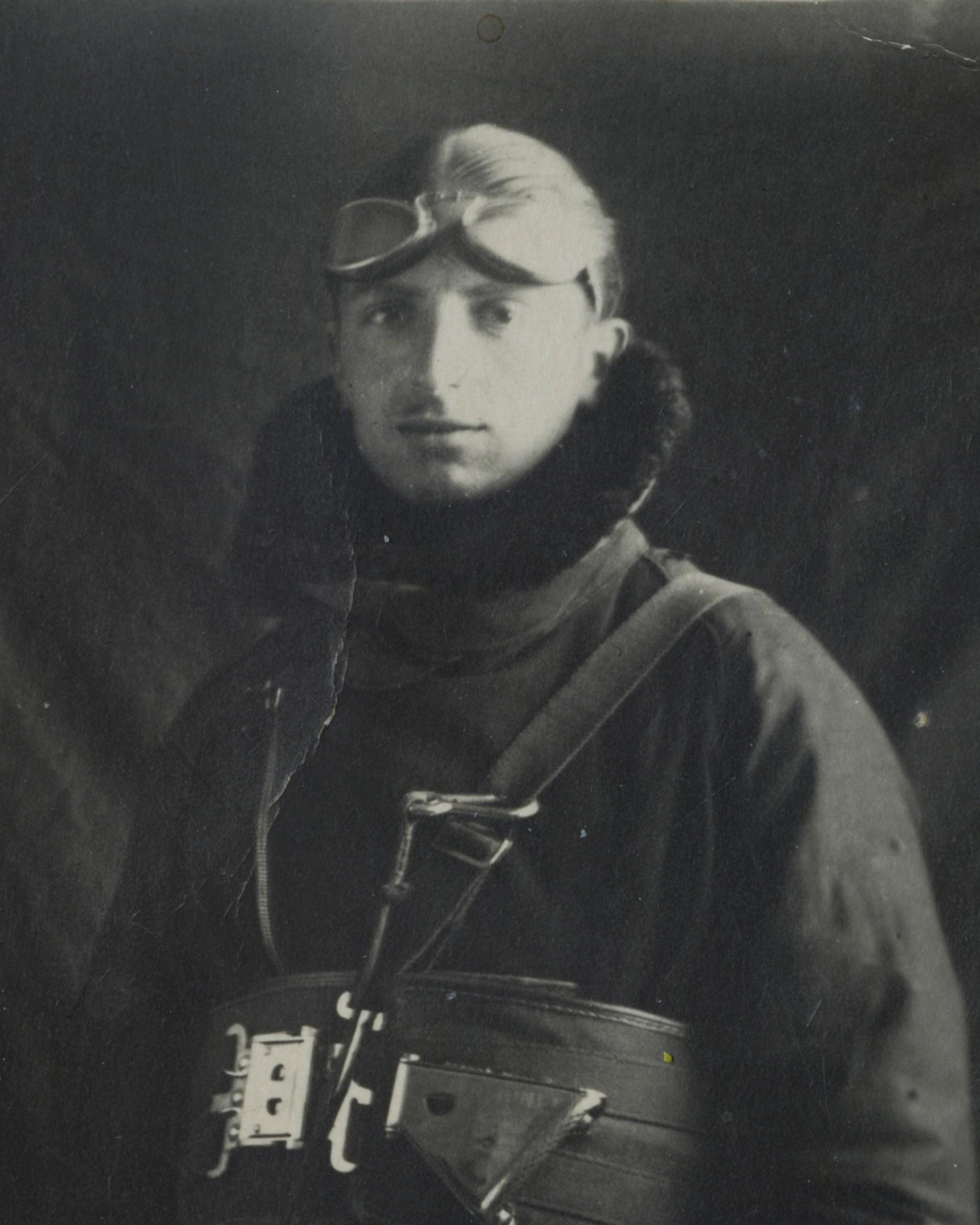 Black-and-white photo of a man in a flight helmet