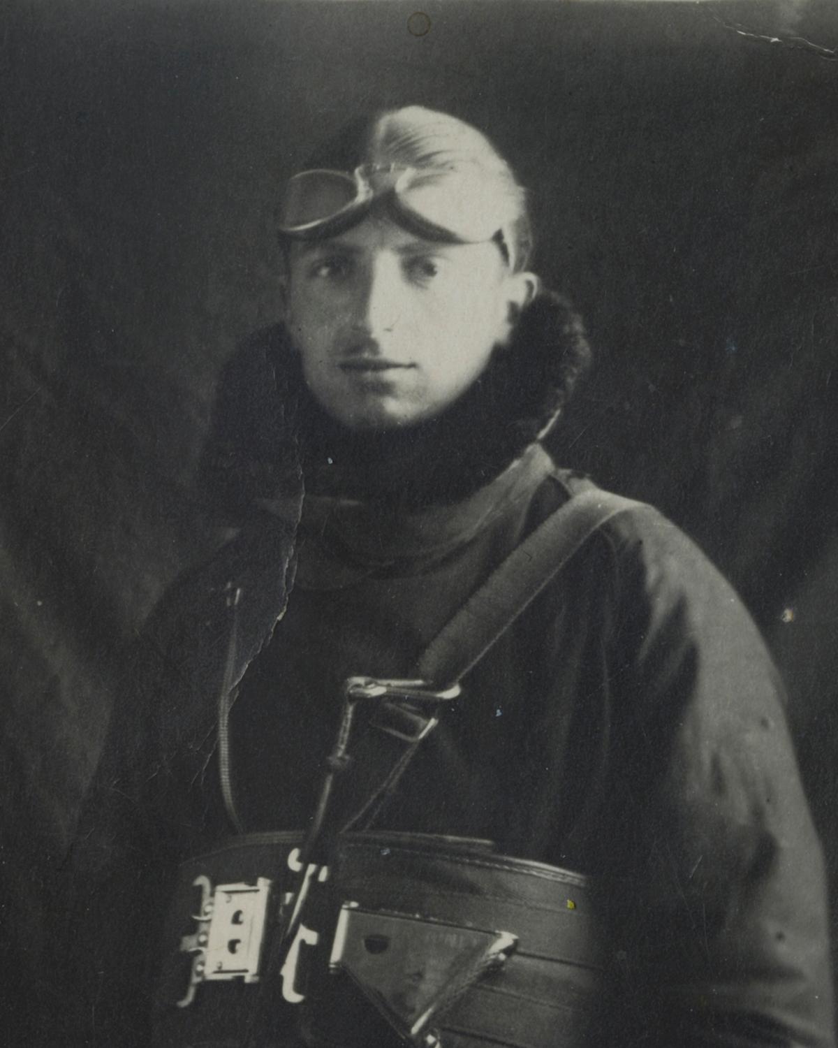 Black-and-white photo of a man in a flight helmet